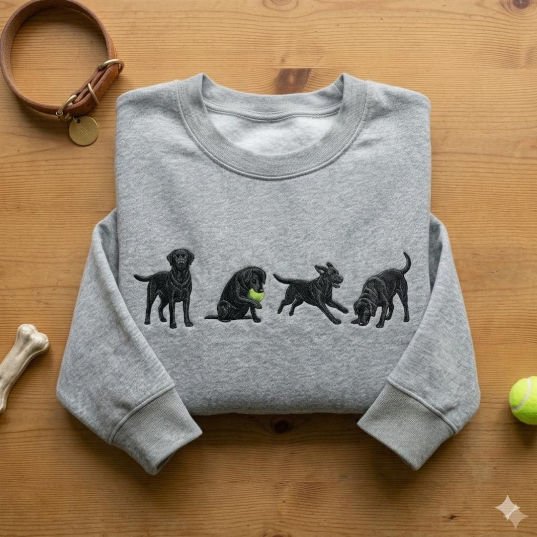 Black Labrador Retriever Four Poses Playing Tennis Ball embroidered sweatshirt — front view