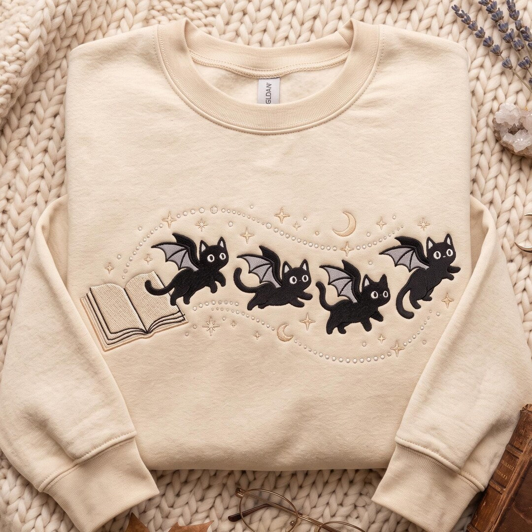 Halloween Black Cat Bat Wings Celestial Moon Stars Book Lover embroidered sweatshirt — front view