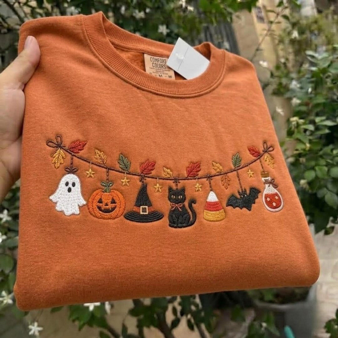 Halloween Spooky Garland Ghost Pumpkin Witch Hat Black Cat Candy Corn Bat Potion embroidered sweatshirt — front view