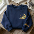 Personalized Frog Reading Book Crescent Moon Stars Left Chest Sleeve Name embroidered sweatshirt — front view