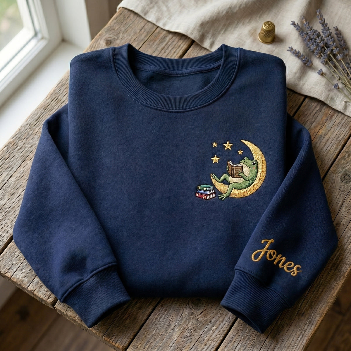 Personalized Frog Reading Book Crescent Moon Stars Left Chest Sleeve Name embroidered sweatshirt — front view