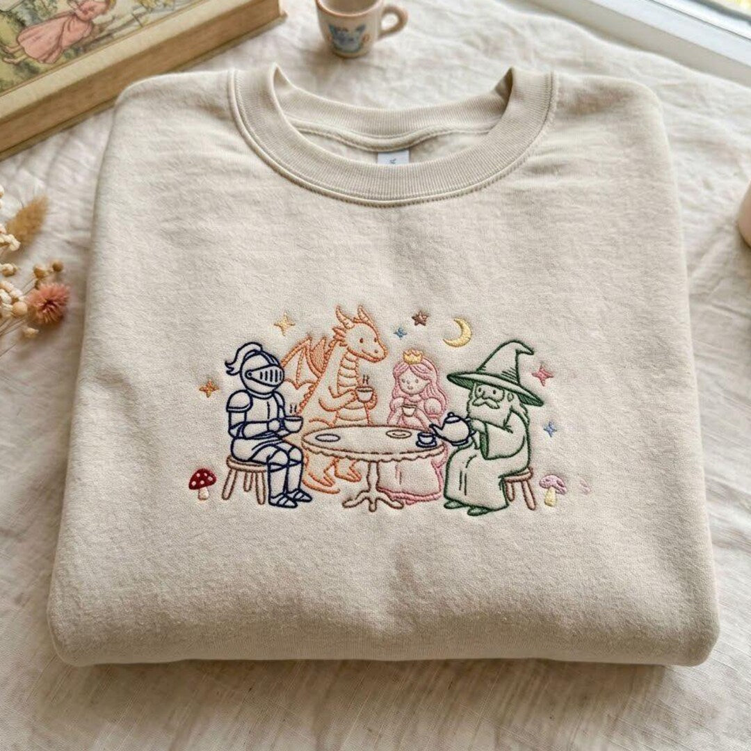 Fantasy Tea Party Knight Dragon Princess Wizard Mushroom Moon Stars embroidered sweatshirt — front view