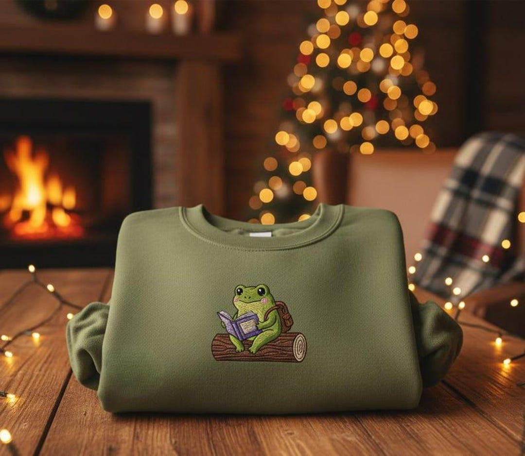 Cute Frog Reading Book on Log Cottagecore Book Lover embroidered sweatshirt — front view