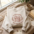 I've Been Reading Since the Late 1900s Stack Books Floral Wreath embroidered sweatshirt — front view