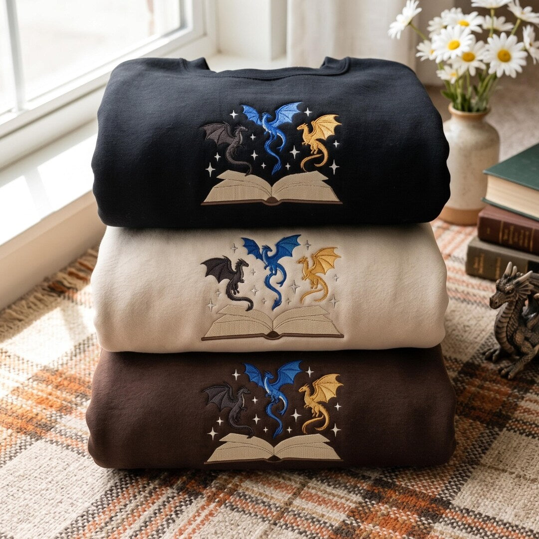Three Dragons Flying Out of Open Book Magic Stars Fantasy Reading embroidered sweatshirt — front view