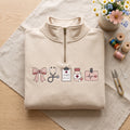 Nurse Coquette Bow Stethoscope Clipboard Medication Ekg embroidered quarter-zip — front view