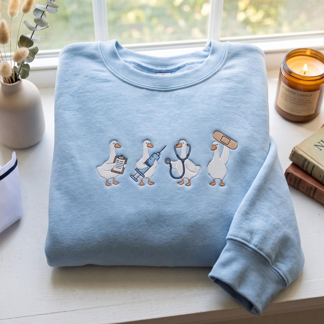Nurse Goose Medical Team Clipboard Syringe Stethoscope Bandage embroidered sweatshirt — front view