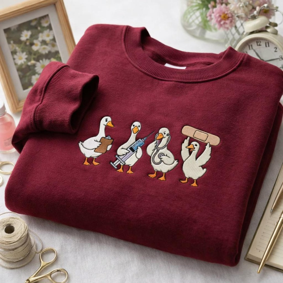Nurse Duck Goose Medical Team Clipboard Stethoscope Band-Aid embroidered sweatshirt — front view