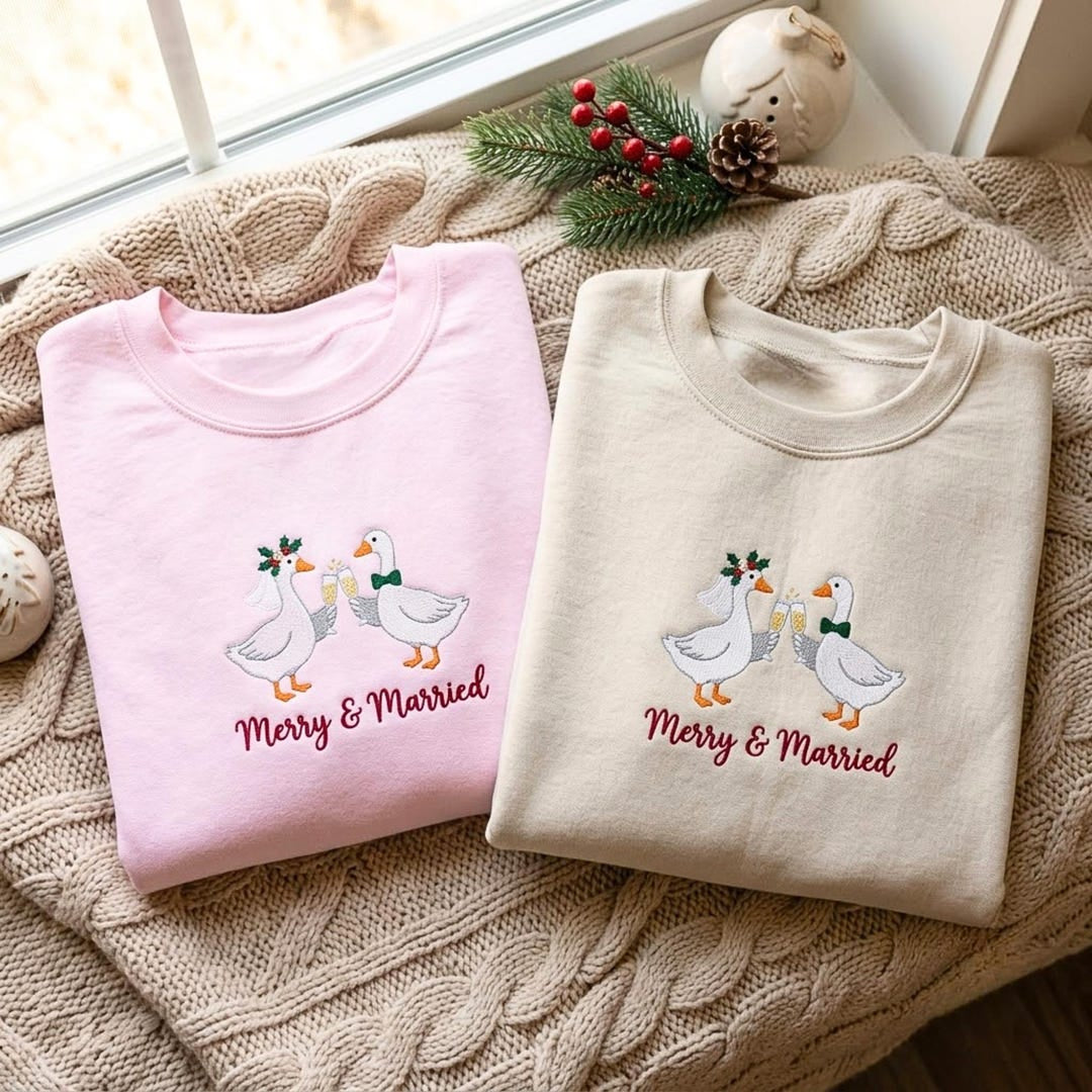 Merry & Married Christmas Geese Couple Champagne Toast Holly embroidered sweatshirt — front view