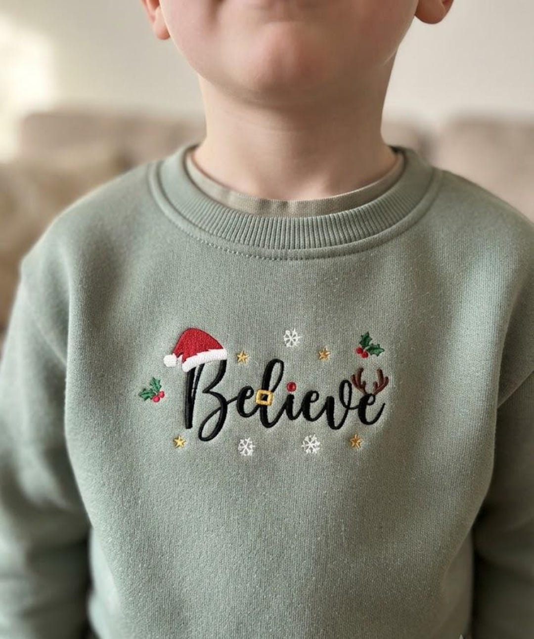 Kids Christmas Believe Santa Hat Reindeer Antlers Holly Snowflakes embroidered sweatshirt — front view