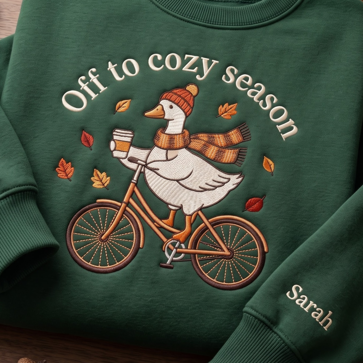 Personalized Cozy Season Goose Riding Bicycle Fall Leaves Coffee embroidered sweatshirt — front view
