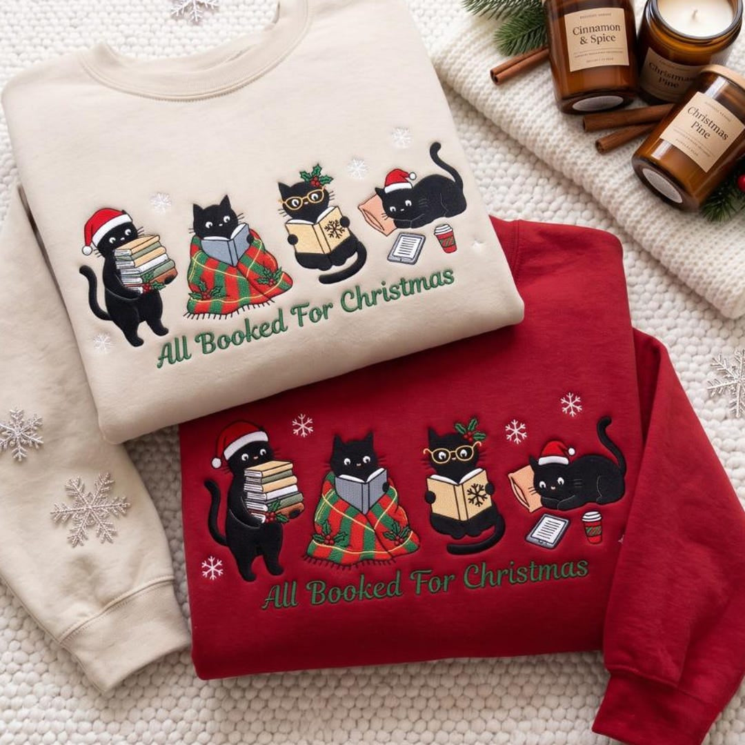 Black Cats Reading Books All Booked for Christmas Santa Hat Plaid Blanket embroidered sweatshirt — front view