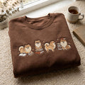 Pomeranian Book Lover Four Poses Reading Dog embroidered sweatshirt — front view