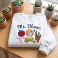 Personalized Teacher Apple Paint Palette School Bus Crayons Scissors embroidered sweatshirt — front view