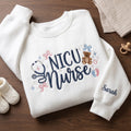 Personalized NICU Nurse Teddy Bear Stethoscope Bows Baby Feet Stars embroidered sweatshirt — front view