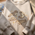 Four Baby Seals Stars Marine Life embroidered sweatshirt — front view