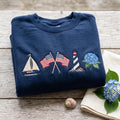 Coastal Sailboat American Flag Lighthouse Hydrangea Nautical embroidered sweatshirt — front view