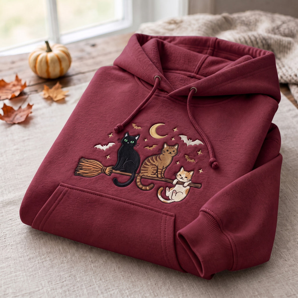 Three Cats Riding Witch Broom Crescent Moon Bats Halloween Embroidered Hoodie — Maroon