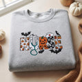Halloween Nurse Pumpkin Jack-O-Lantern Bat Ghost Skull Stethoscope Spooky embroidered sweatshirt — front view