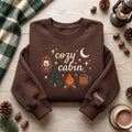 Personalized Cozy Cabin Campfire Lantern Pine Tree Moon Coffee Mug Stars embroidered sweatshirt — front view