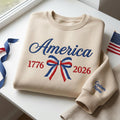Personalized America 1776 2026 Patriotic Coquette Bow Custom Sleeve Name embroidered sweatshirt — front view