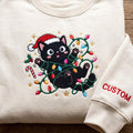 Personalized Christmas Black Cat Santa Hat Tangled Fairy Lights Candy Cane Custom Name embroidered sweatshirt — front view