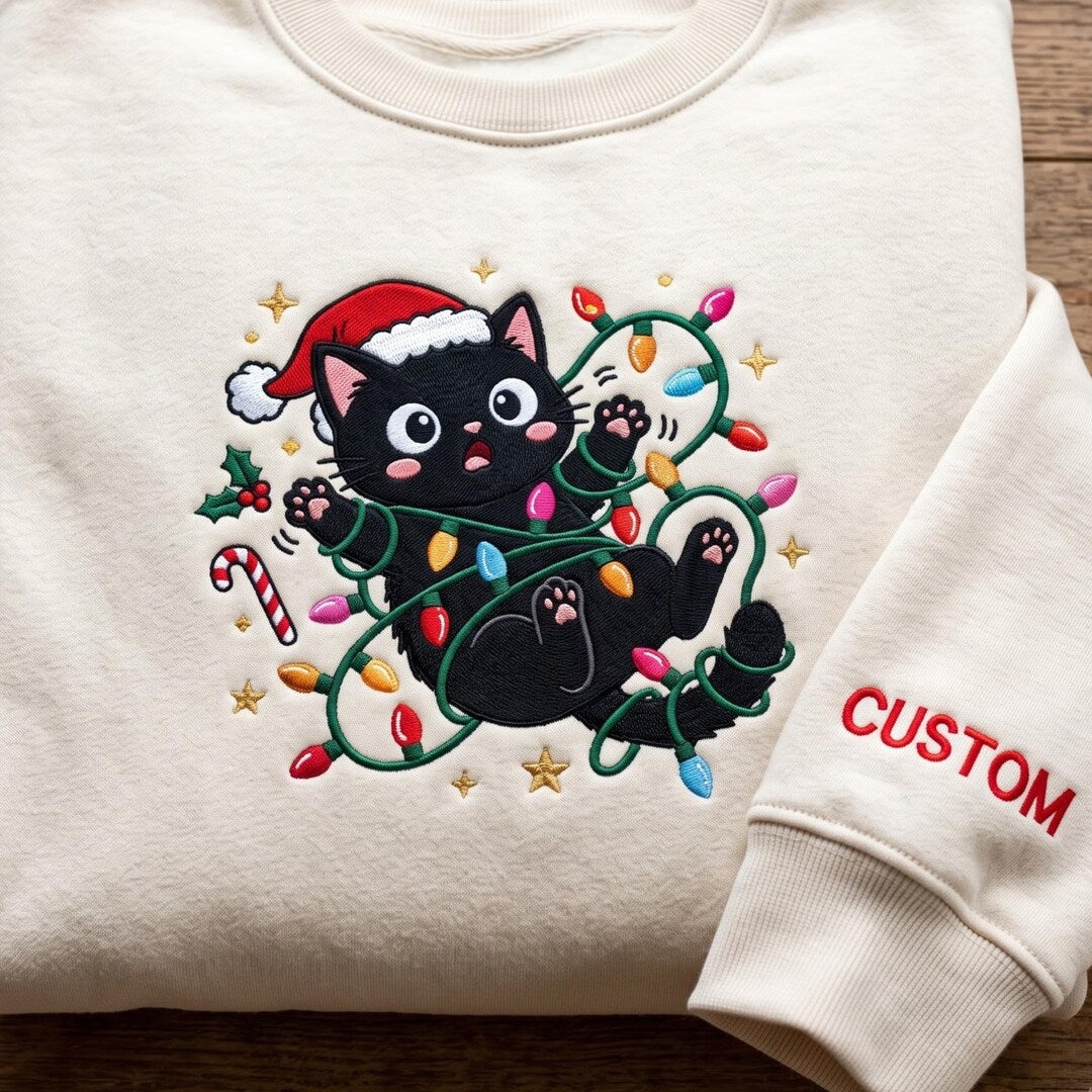 Personalized Christmas Black Cat Santa Hat Tangled Fairy Lights Candy Cane Custom Name embroidered sweatshirt — front view