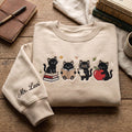 Personalized Teacher Black Cat Reading Book Apple Clipboard Four Cats Custom Name embroidered sweatshirt — front view