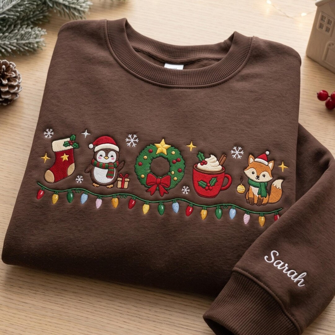 Personalized Christmas Penguin Fox Wreath Stocking Cocoa String Lights Custom Name embroidered sweatshirt — front view