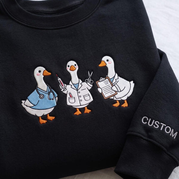 Personalized Medical Goose Trio Nurse Doctor Scrubs Lab Coat Clipboard Custom Sleeve embroidered sweatshirt — front view