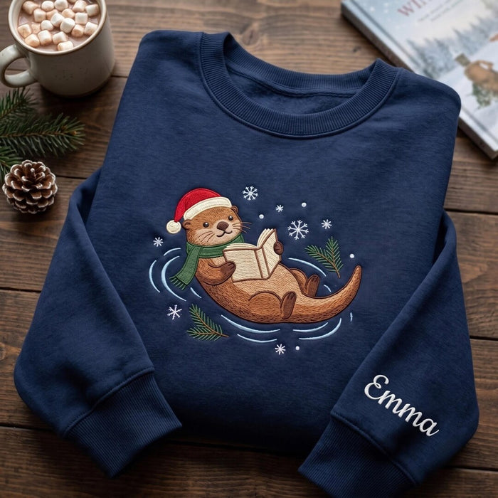 Personalized Christmas Otter Reading Book Santa Hat Scarf Snowflakes Custom Sleeve Name Embroidered Sweatshirt