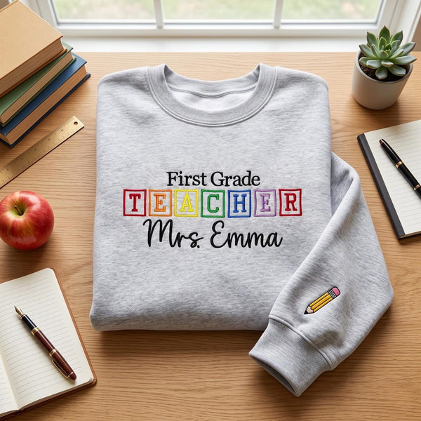 Personalized First Grade Teacher Alphabet Blocks Pencil Sleeve Custom Name embroidered sweatshirt — front view