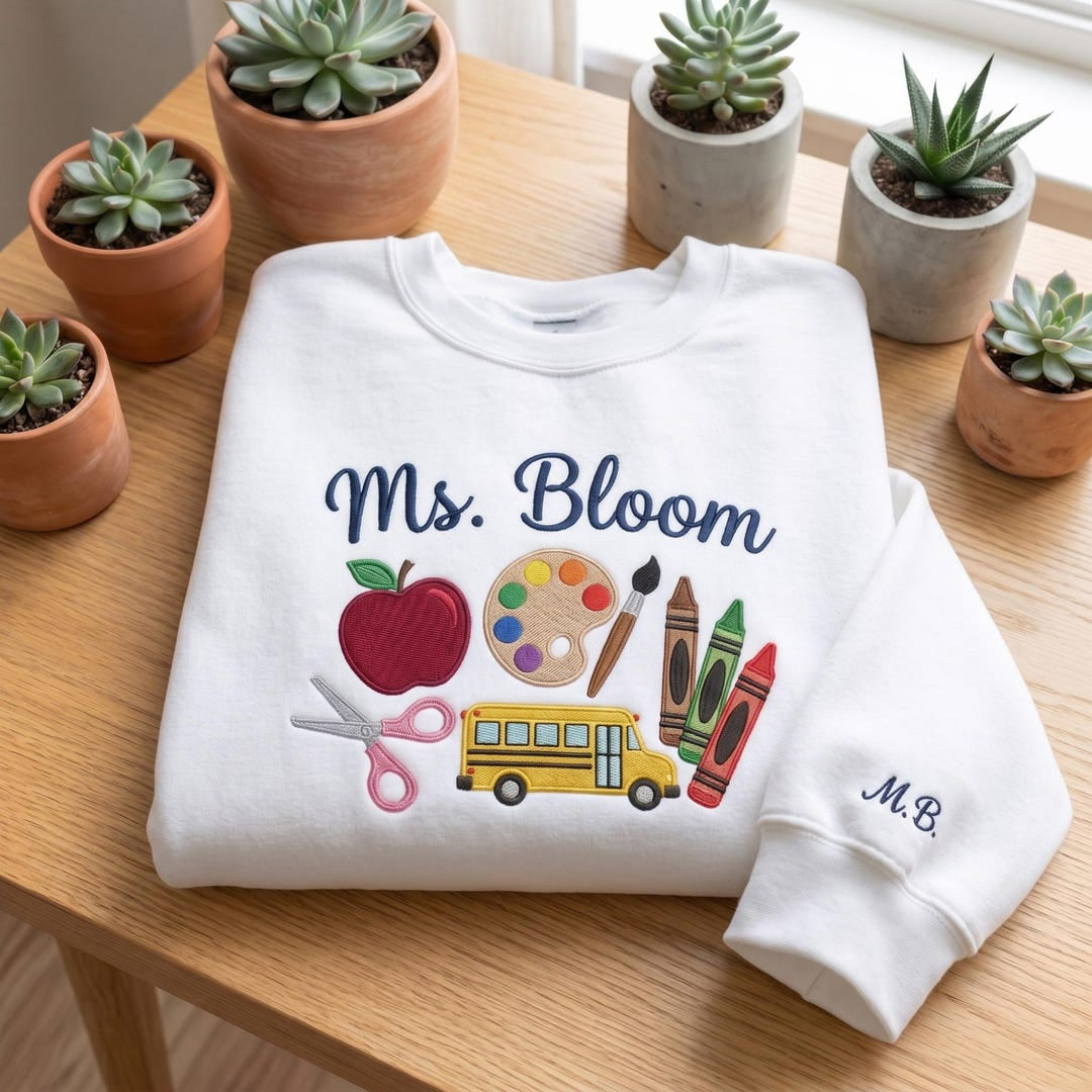 Personalized Teacher Art Supplies Apple School Bus Crayons Scissors Custom Name embroidered sweatshirt — front view