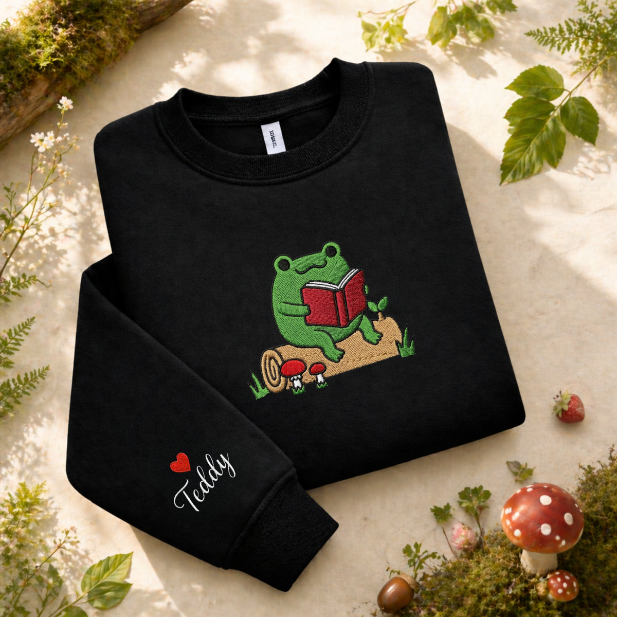 Personalized Frog Reading Book Log Mushroom Cottagecore Sleeve Name embroidered sweatshirt — front view