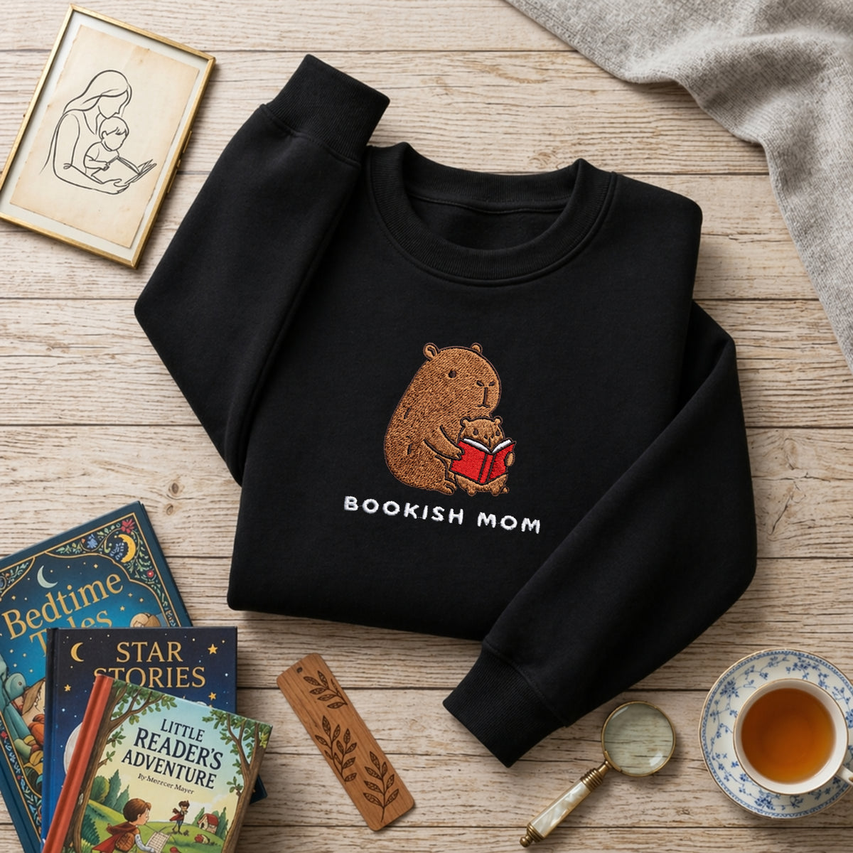 Bookish Mom Capybara Reading with Baby embroidered sweatshirt — front view