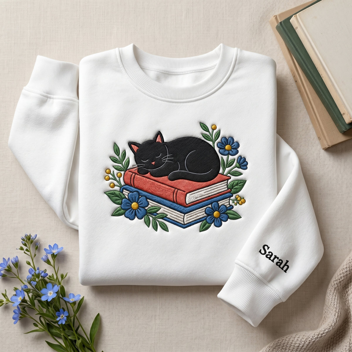 Personalized Black Cat Sleeping on Books Blue Wildflowers Floral embroidered sweatshirt — front view