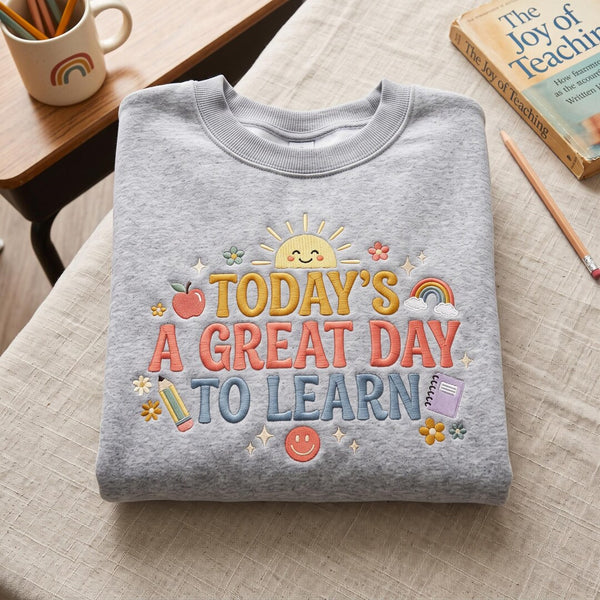 Today's a Great Day to Learn Teacher Sunshine Apple Pencil Rainbow Book embroidered sweatshirt — front view
