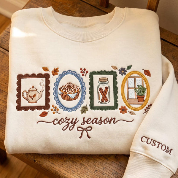 Personalized Cozy Season Tea Cinnamon Roll Window Plant Autumn Frames Custom Name Sleeve embroidered sweatshirt — front view