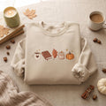 Fall Cozy Coffee Mug Book Oak Leaf Candle Pumpkin Autumn embroidered sweatshirt — front view