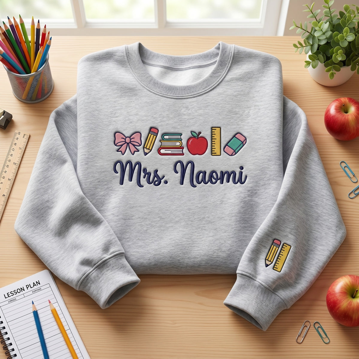 Personalized Teacher Bow Pencil Books Apple Ruler Eraser embroidered sweatshirt — front view