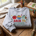 Personalized Back To School Cute Apple Trio Teacher Custom Name Sleeve embroidered sweatshirt - front view