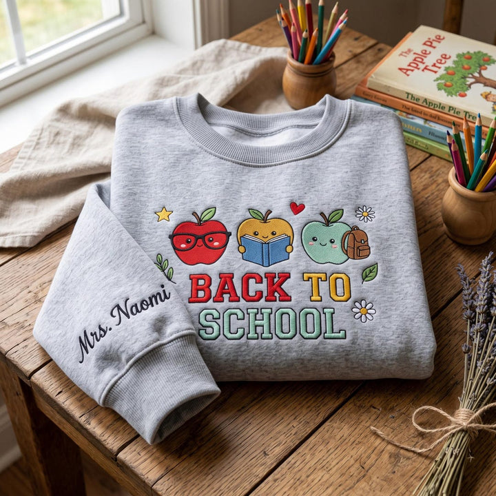 Personalized Back To School Cute Apple Trio Teacher Custom Name Sleeve embroidered sweatshirt - front view