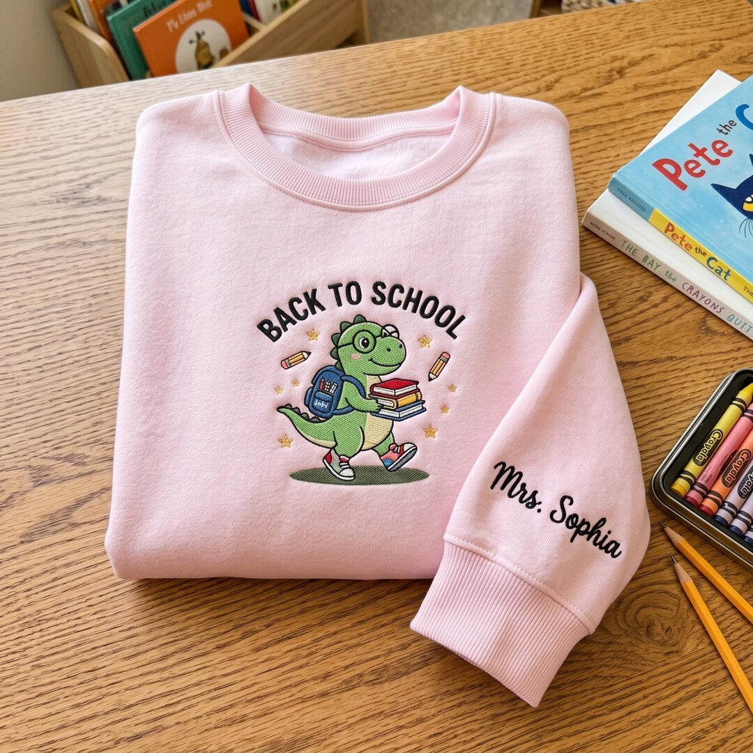 Personalized Back To School Dinosaur Dino Backpack Books Teacher Custom Name Sleeve embroidered sweatshirt - front view
