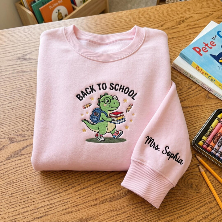 Personalized Back To School Dinosaur Dino Backpack Books Teacher Custom Name Sleeve embroidered sweatshirt - front view