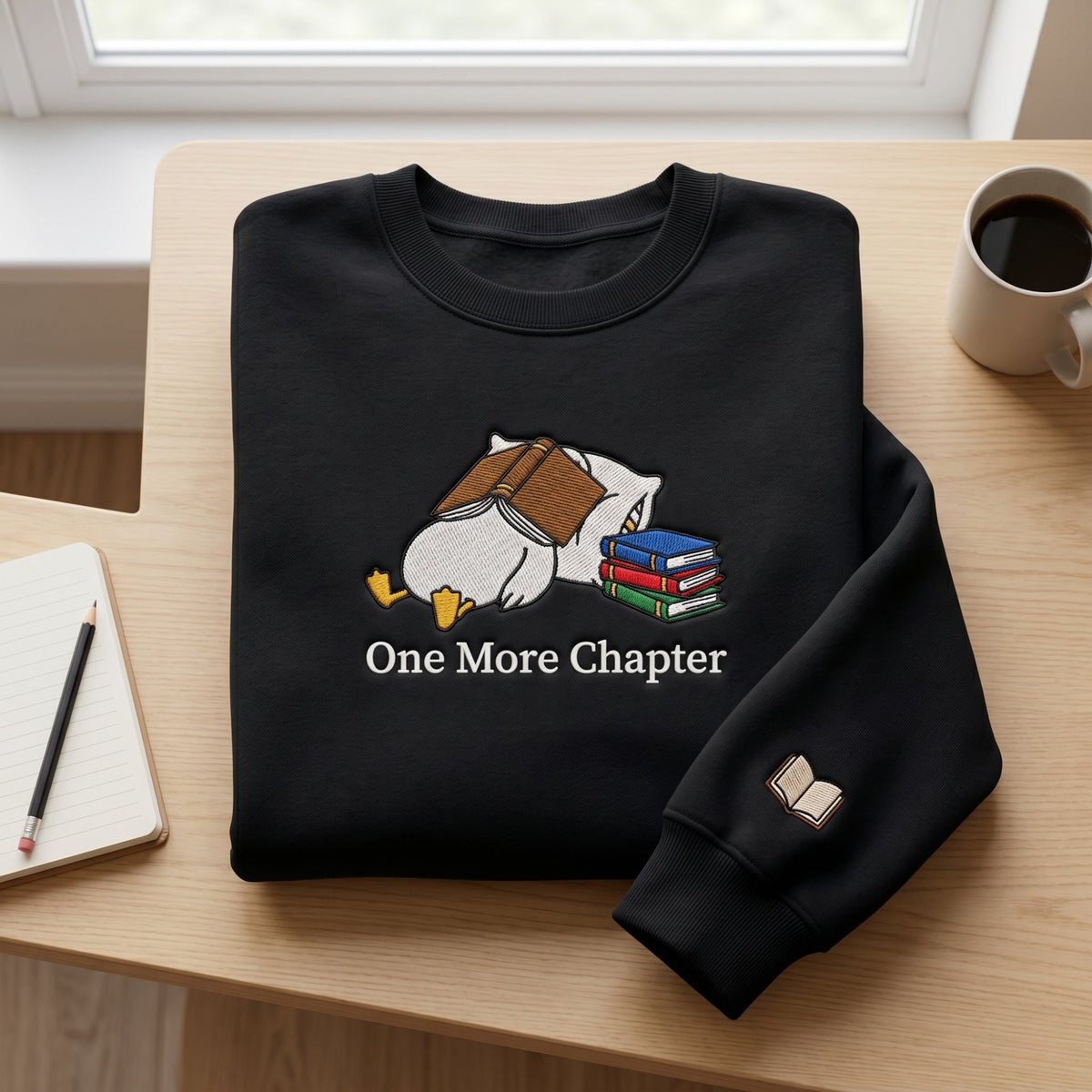 Sleeping Duck Book Stack One More Chapter Reading embroidered sweatshirt - front view