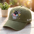 Personalized Black Cat Watering Can Flowers embroidered hat in Amy Green — front view