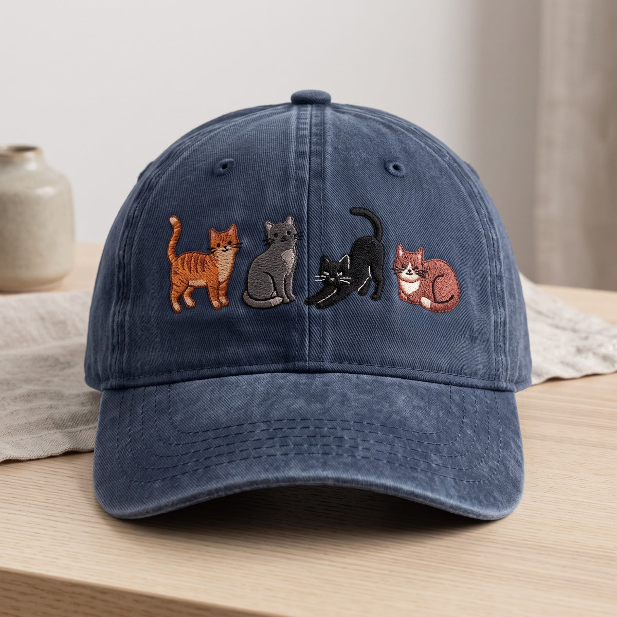 Four Cats Orange Tabby Gray Black Tuxedo Curled Row embroidered hat — front view