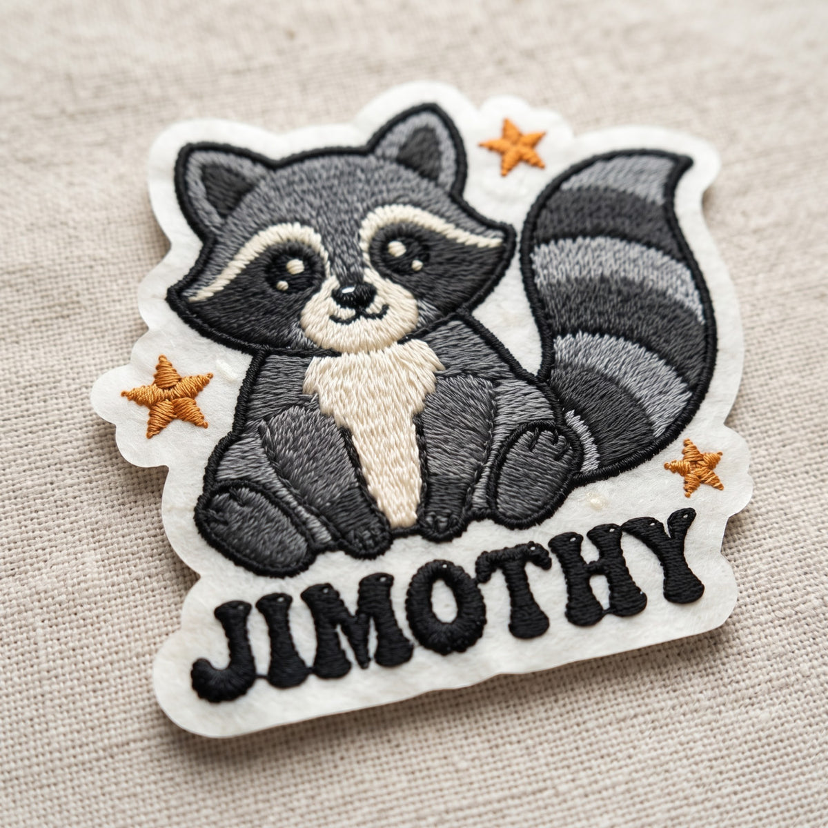 Jimothy Raccoon embroidered patch in 3" — front view