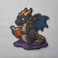 Black Dragon Reading Book Iron On Embroidered Patch — Iron-on patch
