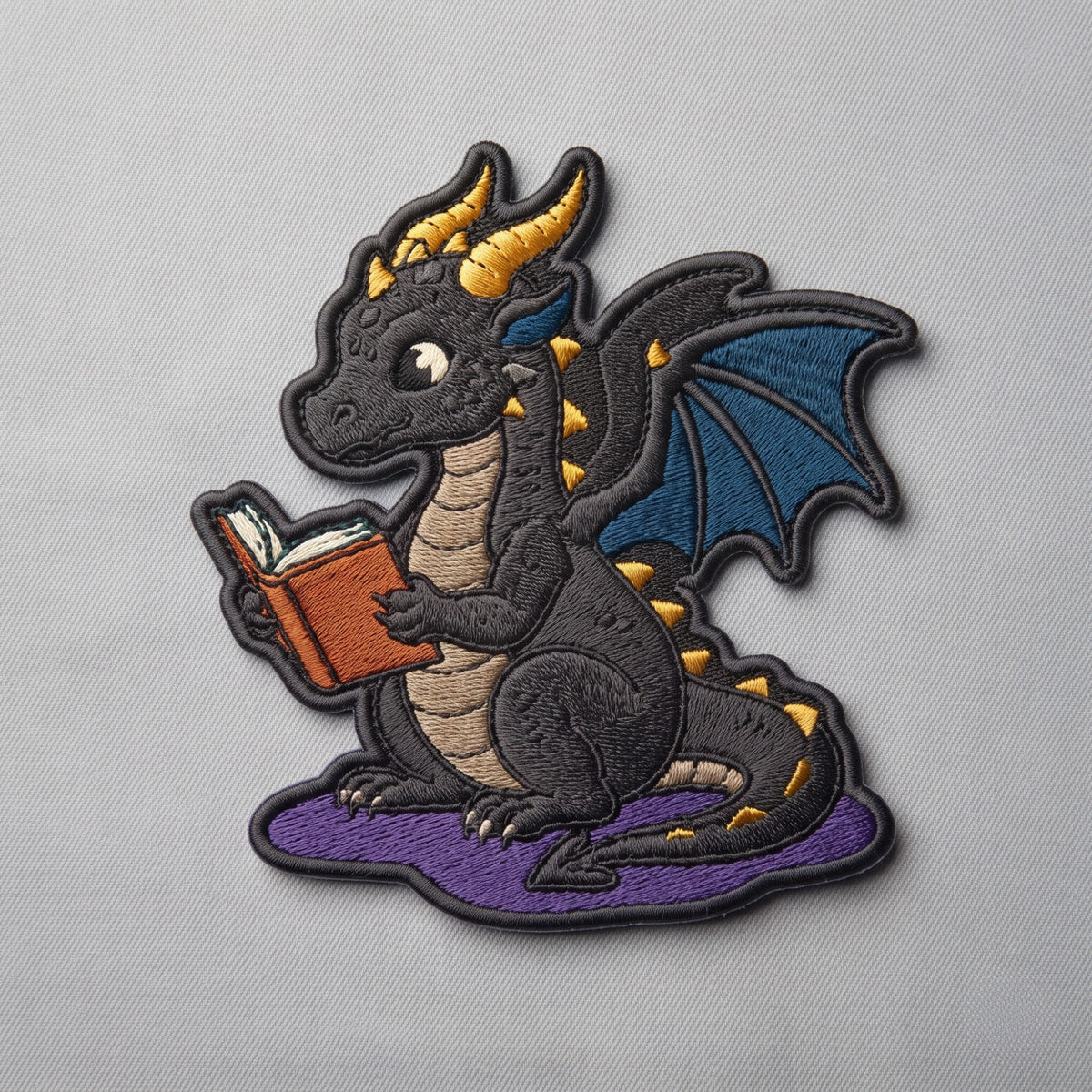 Black Dragon Reading Book Iron On Embroidered Patch — Iron-on patch